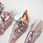 Handmade press-on nails with 3D heart crystals, rhinestones, and pink glitter designs