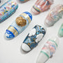 Handmade press-on nails with intricate 3D butterfly, gold, and floral designs on white background