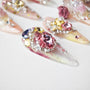 Handmade press-on nails with pink, gold, and clear rhinestone 3D floral embellishments
