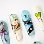 Set of colorful anime-inspired press-on nails with blue hues, rhinestones, and illustrations on white background