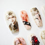 Custom hand-painted anime character nail art with gems and detailed illustrations on white background
