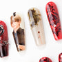 Handmade press-on nails with anime art, abstract patterns, and red floral designs